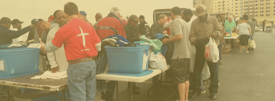 Volunteers passing out clothes to the homeless